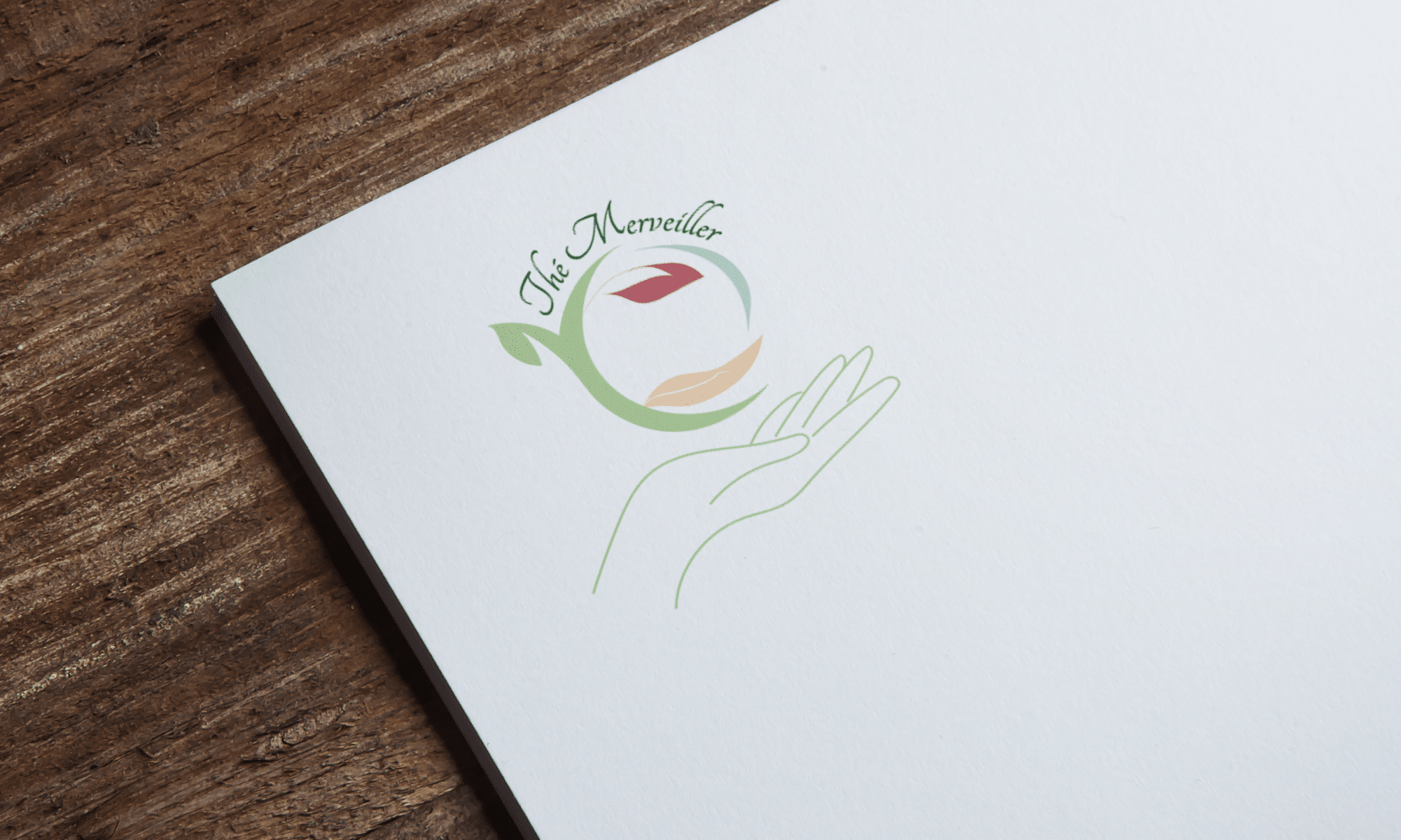 Mise en situation du logo Thé Merveiller sur du papier à en tête.